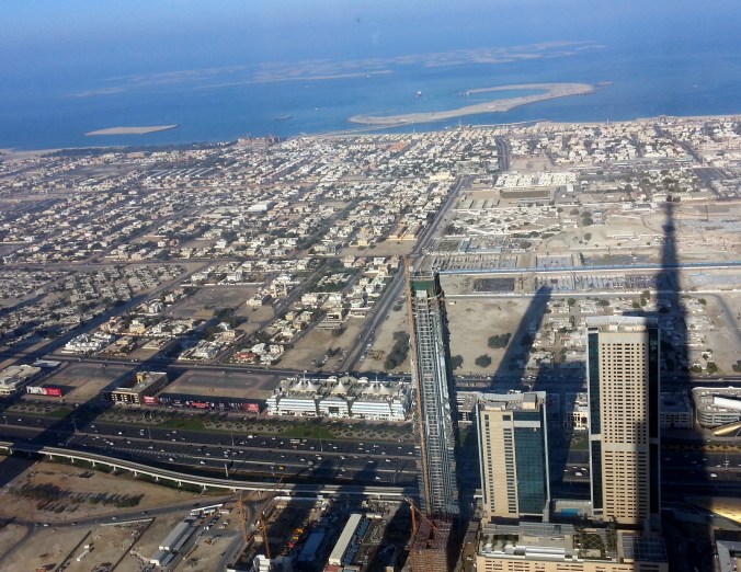 The Burj Khalifa casts a mighty long shadow. It almost reaches Palm Jumeirah (the palm shaped islands at the top of the photo).